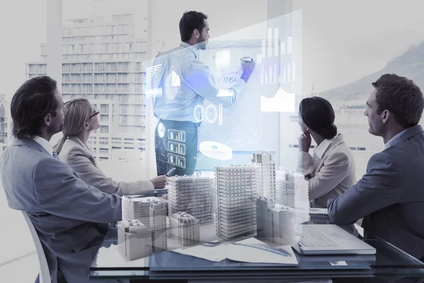 Composite image of team working on digital skycrapers — Stock Photo, Image