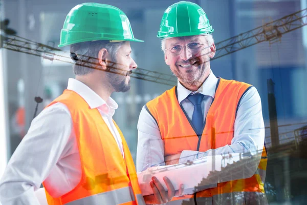 Composite image of men on building construction site — Stock Photo, Image