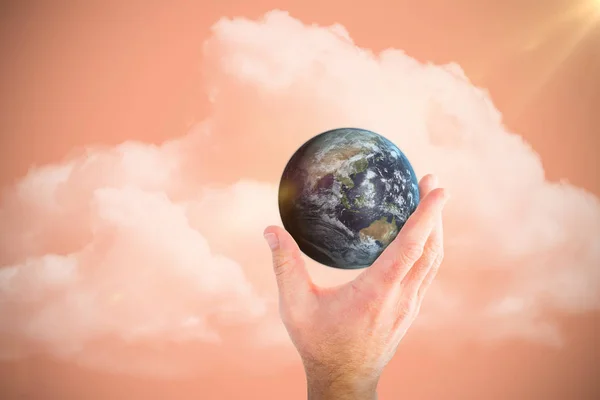 Composite image of hand presenting little earth — Stock Photo, Image