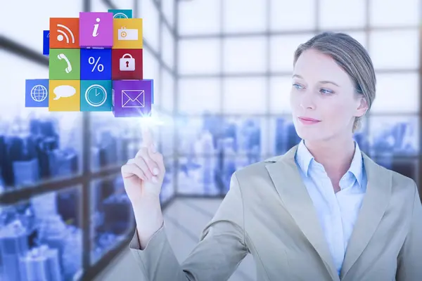 Composite image of businesswoman pointing cube with her finger — Stock Photo, Image