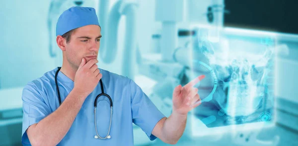 Composite image of surgeon pretending to be using futuristic digital screen — Stock Photo, Image