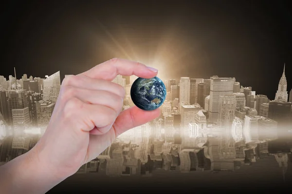 Composite image of close-up of hand holding little earth — Stock Photo, Image