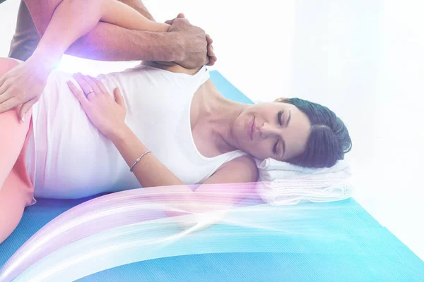 Doctor giving physiotherapy to pregnant woman — Stock Photo, Image