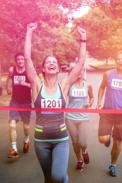 Happy woman crossing the finish line — Stock Photo, Image