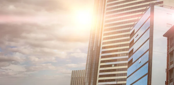 Composite image of sky over modern buildings — Stock Photo, Image