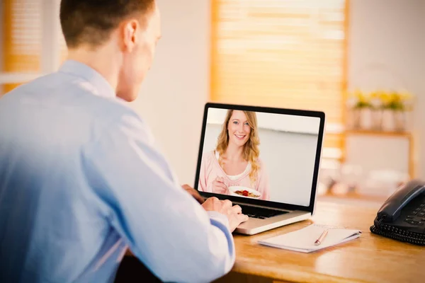 Imagem composta de empresário trabalhando em seu laptop — Fotografia de Stock