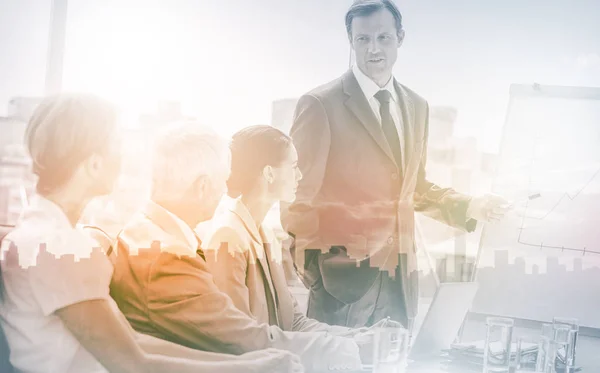 Businessman pointing at whiteboard during a meeting — Stock Photo, Image