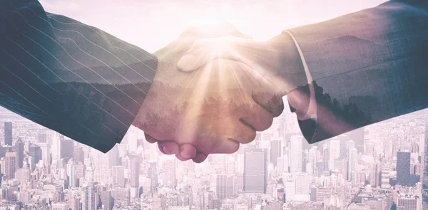 Composite image of business people shaking hands — Stock Photo, Image