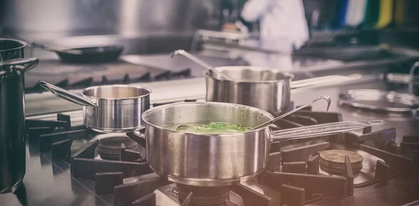 Different pots cooking on hotplate — Stock Photo, Image