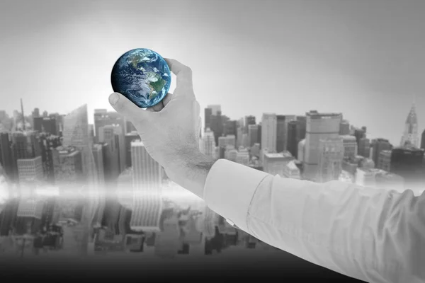 Composite image of businessman holding hand out little earth in presentation Royalty Free Stock Images