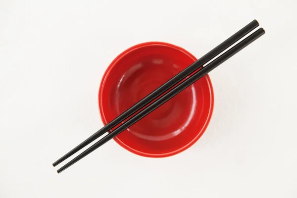 Pair of chopsticks over a bowl — Stock Photo, Image