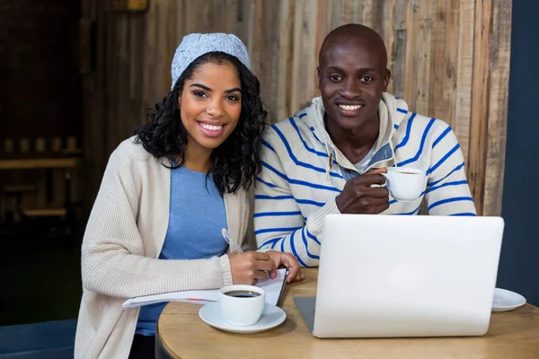 Smiling couple having cup of coffee in cafe — Stock Photo, Image