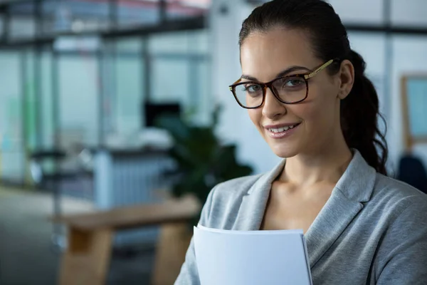Beautiful woman smiling in office — Stock Photo, Image
