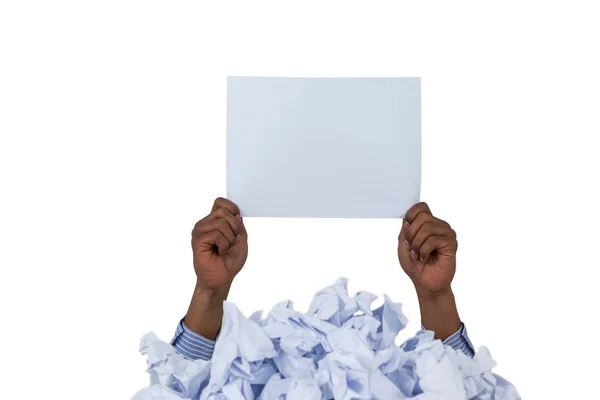 Heap of crumpled paper with hand holding blank page — Stock Photo, Image