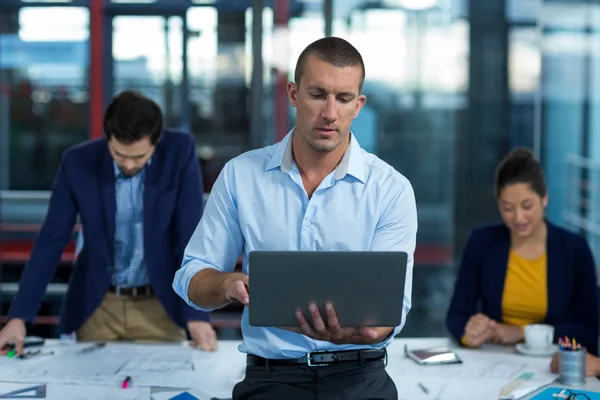 Male business executive using laptop — Stock Photo, Image