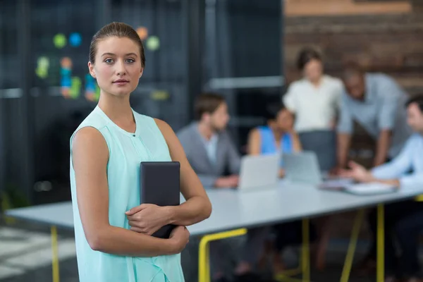 Business executive standing with digital tablet in office — Stock Photo, Image