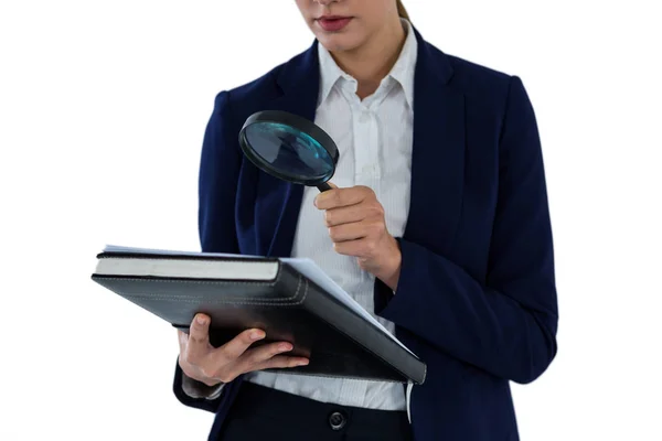 Businesswoman looking at document through magnifying glass — Stock Photo, Image