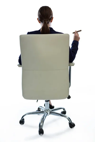 Rear view of businesswoman holding cigar — Stock Photo, Image