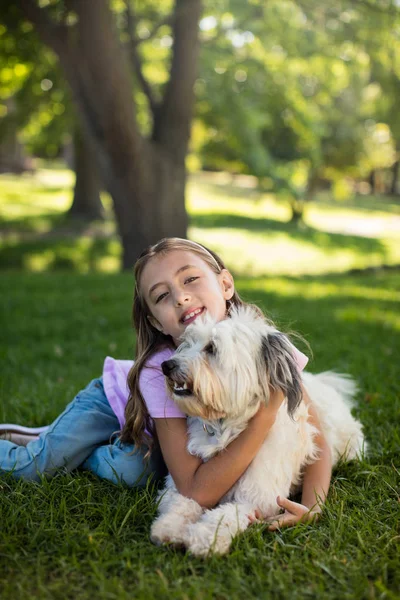 Portrait of girl with dog in park — Stock Photo, Image