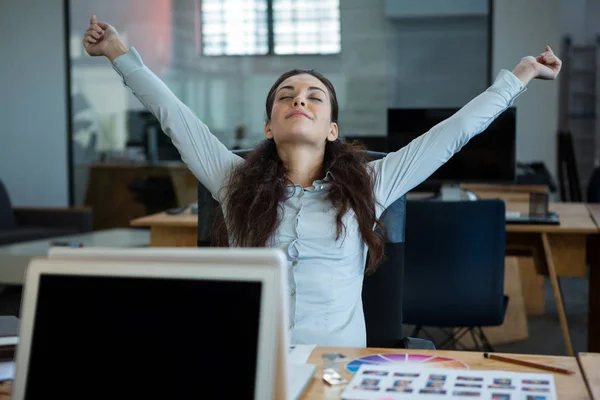 Graphic designer stretching her arms out — Stock Photo, Image