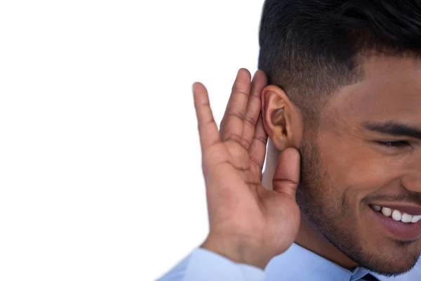 Zakenman met hand op oor te luisteren — Stockfoto