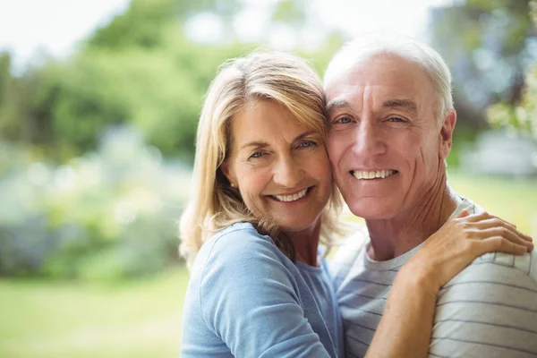 Portrait of senior couple embracing outdoors — Stock Photo, Image