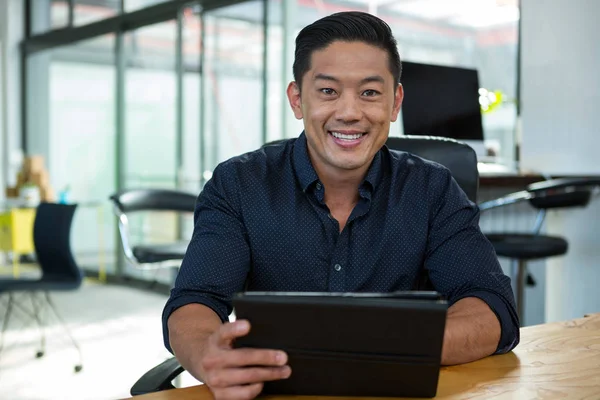 Portrait of business executive holding digital tablet