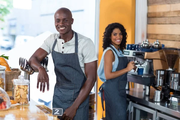 Portrait of smiling waitress and waiter working at counter — Stock Photo, Image