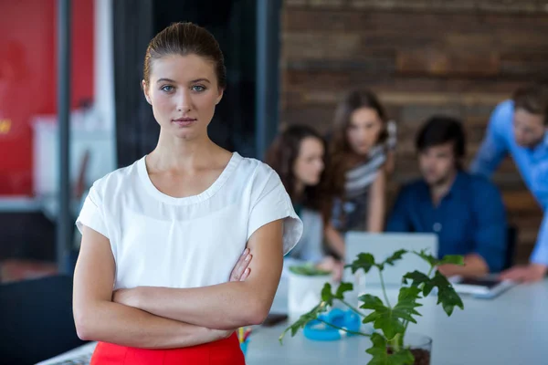 Porträtt av kvinnliga business executive stående med armarna korsade — Stockfoto