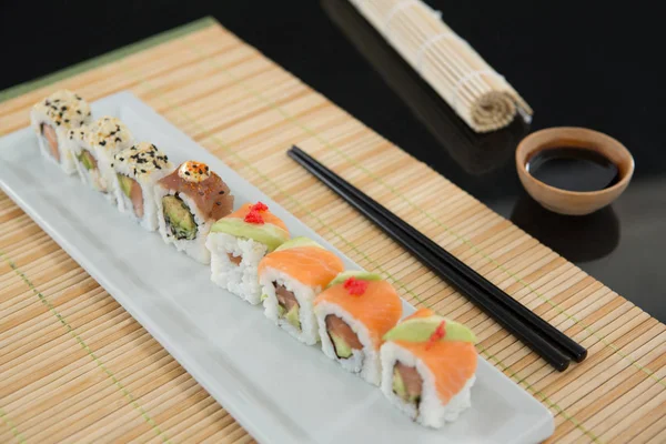 Sushi på matta med pinnar — Stockfoto