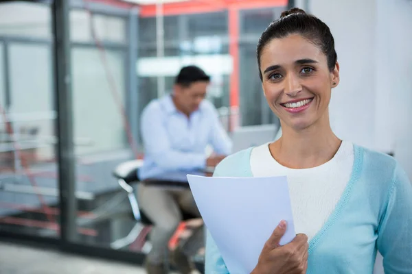 Portrait of smiling businesswoman standing with document — Stock Photo, Image