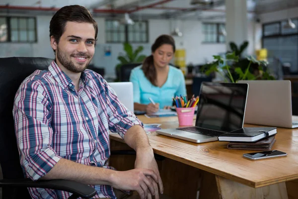 Portrait of business executive working on desk in office — Stock Photo, Image