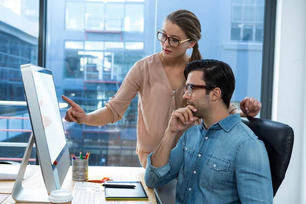 Diseñador gráfico trabajando en el escritorio con su colega —  Fotos de Stock