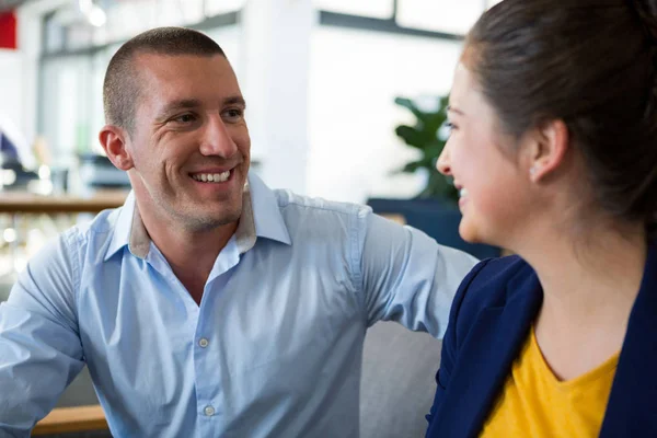 Smiling business executives interacting with each other — Stock Photo, Image