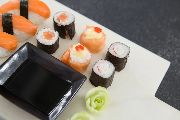 Olika sushi på bricka med sås — Stockfoto