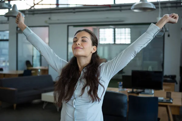 Graphic designer stretching her arms out — Stock Photo, Image