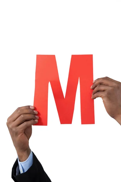 Businessman holding an alphabet m — Stock Photo, Image