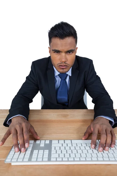 Porträt eines Geschäftsmannes, der am Schreibtisch auf der Tastatur tippt — Stockfoto