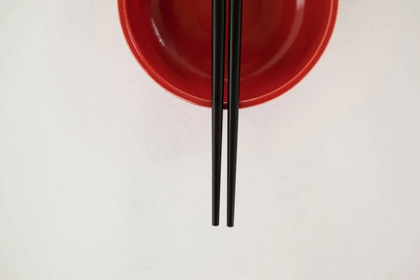 Pair of chopsticks over a bowl — Stock Photo, Image