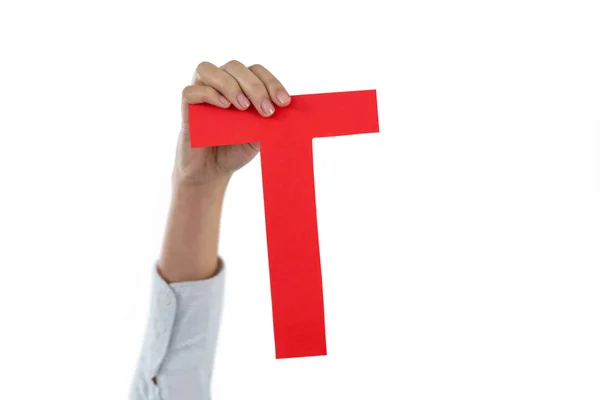 Empresária segurando um alfabeto T — Fotografia de Stock