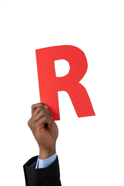 Businessman holding an alphabet r — Stock Photo, Image