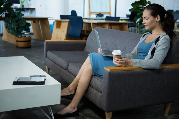 Female business executive using laptop — Stock Photo, Image