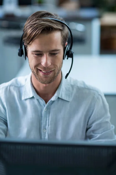 Företagsledare med headset i office — Stockfoto