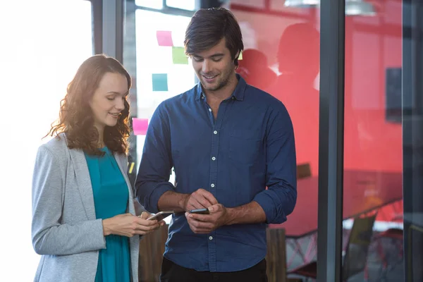 Männliche und weibliche Führungskräfte mit Mobiltelefon — Stockfoto