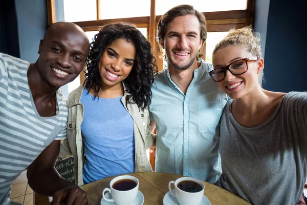 Portret uśmiechający się przyjaciółmi w kawiarni — Zdjęcie stockowe