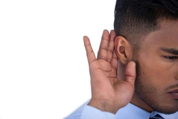 Geschäftsmann hört mit der Hand am Ohr zu — Stockfoto