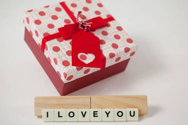 Gift and blocks displaying I love you message — Stock Photo, Image