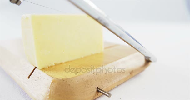 Cheese slicer slicing cheese — Stock Video