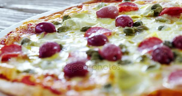 Baked pizza on wooden table — Stock Video