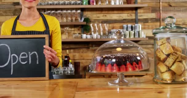 Waitress showing slate with open sign — Stock Video